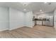 Bright kitchen with stainless steel appliances, white cabinets, and hardwood floors at 7074 Babbling Brook Dr, Jonesboro, GA 30236