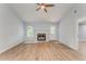 Open living room featuring a cozy fireplace, light walls, and stylish flooring at 7074 Babbling Brook Dr, Jonesboro, GA 30236