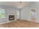Bright living room with a fireplace, hardwood floors, and access to other rooms at 7074 Babbling Brook Dr, Jonesboro, GA 30236