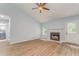 Light-filled living room featuring a fireplace, neutral paint, and door to porch at 7074 Babbling Brook Dr, Jonesboro, GA 30236