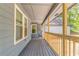 Spacious covered porch with wood railing, offering an inviting outdoor space at 7074 Babbling Brook Dr, Jonesboro, GA 30236