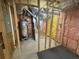 View of the unfinished basement showing framing, insulation, and the home's water heater and furnace at 955 Tributary Way, Dacula, GA 30019