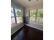 Bright breakfast nook features lots of windows, dark wood flooring and built in shelves at 955 Tributary Way, Dacula, GA 30019