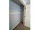This closet features a shelf, neutral paint, and carpeted floors, offering storage and organization at 955 Tributary Way, Dacula, GA 30019