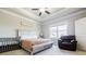 Spacious main bedroom suite with tray ceilings, plenty of natural light, and a large bed at 10035 River Rock Dr, Roswell, GA 30076
