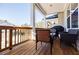 Comfortable covered porch with wood railing and stylish outdoor furniture; grill present at 10035 River Rock Dr, Roswell, GA 30076