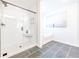 Modern bathroom featuring a glass-enclosed shower, a soaking tub, and sleek gray tile flooring for a spa-like retreat at 1795 Fulmont Cir, Mableton, GA 30126