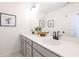 Bathroom features a double vanity with stone countertop, black faucets and framed botanical art at 1795 Fulmont Cir, Mableton, GA 30126