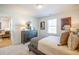 Bright bedroom features a stylish bed, decor and a view into the living room at 1795 Fulmont Cir, Mableton, GA 30126