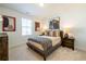 Cozy bedroom with neutral tones, carpet flooring, and a stylish decorative throw blanket at 1795 Fulmont Cir, Mableton, GA 30126