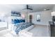 Spacious primary bedroom with a plush carpet, a white bed with blue decorative pillows, and modern decor at 1795 Fulmont Cir, Mableton, GA 30126