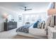 Bright bedroom featuring large windows, a ceiling fan, and a comfortable bed with stylish blue and white bedding at 1795 Fulmont Cir, Mableton, GA 30126