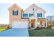 Inviting two-story home showcasing a brick facade, a two-car garage, and a meticulously landscaped front yard at 1795 Fulmont Cir, Mableton, GA 30126