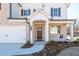 Charming home exterior highlighting a brick facade, an inviting front porch, and manicured landscaping at 1795 Fulmont Cir, Mableton, GA 30126