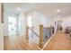 Well-lit hallway with modern railing and stylish decor leading to bedrooms at 1795 Fulmont Cir, Mableton, GA 30126