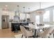Bright kitchen with white cabinets, a stylish chandelier, and a dining area with seating for six at 1795 Fulmont Cir, Mableton, GA 30126