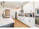 Bright kitchen featuring white cabinets, stainless steel appliances, and quartz countertops at 1795 Fulmont Cir, Mableton, GA 30126