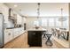Spacious kitchen with stainless steel appliances, central island, and adjacent dining area under a modern chandelier at 1795 Fulmont Cir, Mableton, GA 30126