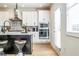 Bright kitchen featuring white cabinetry, stainless steel appliances, and a kitchen island with barstool seating at 1795 Fulmont Cir, Mableton, GA 30126