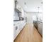 Bright kitchen featuring white cabinetry, stainless steel appliances, and wood-look flooring at 1795 Fulmont Cir, Mableton, GA 30126