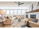 Open-concept living room featuring a fireplace, abundant natural light, and hardwood floors for a seamless flow at 1795 Fulmont Cir, Mableton, GA 30126