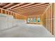 Unfinished basement space ready for customization, featuring concrete walls, exposed ceiling, and natural light through multiple windows at 2395 Kilgore Road (Lot 7) Rd, Buford, GA 30519