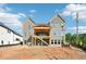New construction home featuring a brick facade, covered porch, and multi-story design, awaiting landscaping at 2395 Kilgore Road (Lot 7) Rd, Buford, GA 30519