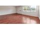 Bright living room with gleaming hardwood floors and natural light from a large window at 290 Lakemoore Ne Dr # C, Atlanta, GA 30342