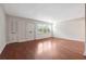 Empty living room features hardwood floors, a large closet, and natural light at 290 Lakemoore Ne Dr # C, Atlanta, GA 30342