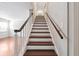 Stairway with wooden steps and handrails leading to the upper level at 290 Lakemoore Ne Dr # C, Atlanta, GA 30342