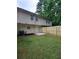 Backyard view of house, a patio, a wood fence, and green lawn at 5538 Pineridge Ct, Forest Park, GA 30297