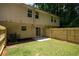 Spacious backyard with new fence, patio, lawn and view of the home's exterior at 5538 Pineridge Ct, Forest Park, GA 30297