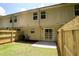 View of the home's exterior and fenced backyard with a small patio and lawn at 5538 Pineridge Ct, Forest Park, GA 30297