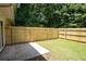 Enclosed backyard featuring a wood fence, small patio and a grass area at 5538 Pineridge Ct, Forest Park, GA 30297