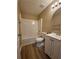 Well-lit bathroom featuring a shower-tub combo, vinyl floors, and a white vanity with modern fixtures at 5538 Pineridge Ct, Forest Park, GA 30297