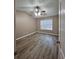 Spacious bedroom with vaulted ceiling, wood-look flooring, and ample natural light from a large window at 5538 Pineridge Ct, Forest Park, GA 30297