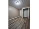 Bedroom with vinyl plank flooring, neutral paint, a closet, and modern ceiling light at 5538 Pineridge Ct, Forest Park, GA 30297