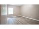 Bright bedroom with hardwood floors, neutral walls, and a window providing natural light at 5538 Pineridge Ct, Forest Park, GA 30297