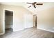 Inviting bedroom with hardwood floors, a ceiling fan, and an adjoining bathroom at 5538 Pineridge Ct, Forest Park, GA 30297