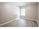 Cozy bedroom featuring natural light, neutral walls, and hardwood floors at 5538 Pineridge Ct, Forest Park, GA 30297