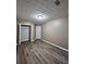 Bedroom featuring neutral paint, wood-look floors, and a spacious closet at 5538 Pineridge Ct, Forest Park, GA 30297