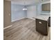 Open-concept dining area with access to the kitchen, featuring wood-look flooring, and neutral paint at 5538 Pineridge Ct, Forest Park, GA 30297