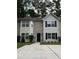 Charming two-story townhome featuring a brick facade, neutral siding, and a well-maintained front lawn at 5538 Pineridge Ct, Forest Park, GA 30297