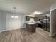 Eat-in kitchen features granite countertops, stainless steel appliances, wood-look floors, and pendant lighting at 5538 Pineridge Ct, Forest Park, GA 30297
