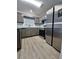 Stylish kitchen features stainless steel appliances, granite countertops, wood-look floors, and natural light at 5538 Pineridge Ct, Forest Park, GA 30297