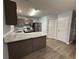 Bright kitchen features updated granite counters, stainless steel appliances, and modern wood-look flooring at 5538 Pineridge Ct, Forest Park, GA 30297