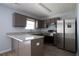 Bright kitchen featuring stainless steel refrigerator, granite counters, and updated cabinets at 5538 Pineridge Ct, Forest Park, GA 30297