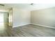 Bright, neutral living room with light wood-look floors and open door to kitchen at 5538 Pineridge Ct, Forest Park, GA 30297