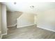 Open living room with luxury vinyl plank flooring and staircase access at 5538 Pineridge Ct, Forest Park, GA 30297