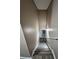 Stairway featuring hardwood stairs, neutral paint, and a white railing at 5538 Pineridge Ct, Forest Park, GA 30297